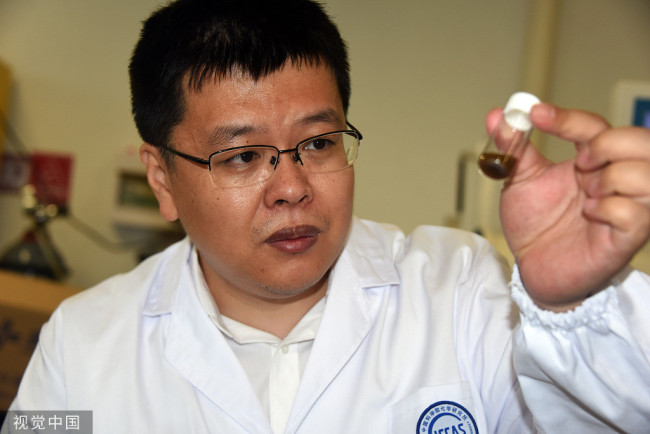 2022年6月16日，北京，论文通讯作者郑健研究员在中科院化学所实验室展示介绍含有碳家族单晶新材料——单层聚合碳60的样品。