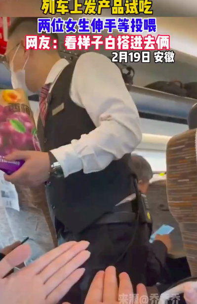 俩女生伸手等列车员投喂