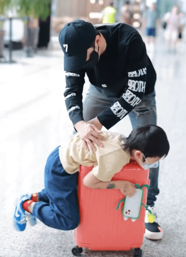 黄晓明带着儿子现身机场 小海绵玩转行李箱超可爱