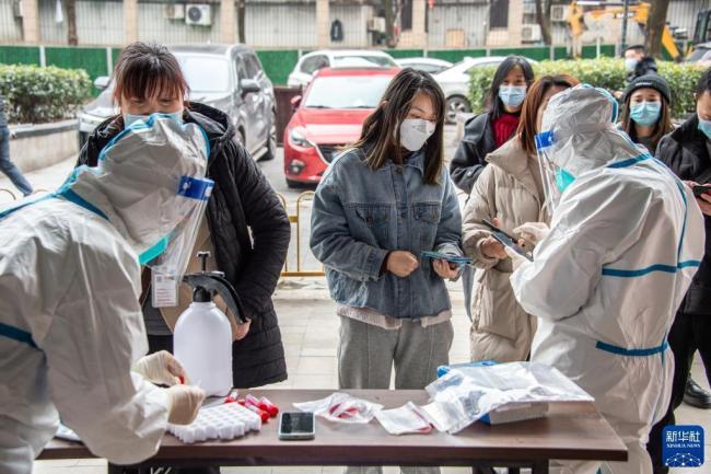 在武汉市圆梦家园社区核酸检测点进行核酸检测。新华社伍志尊摄