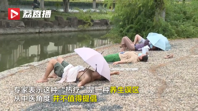 公园鹅卵石地面躺满市民做热疗