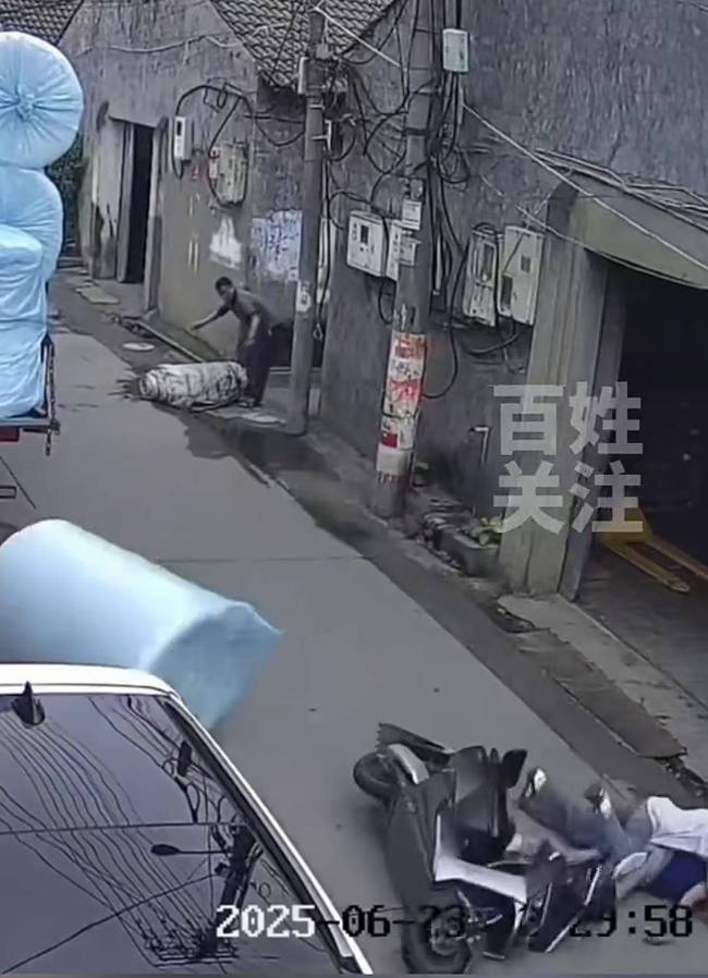 监控：2人骑电动车经过被掉落货物砸倒