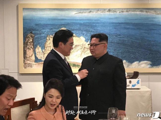 资料图，2018年4月27日，朝鲜劳动党总书记金正恩在板门店和平之家举行的欢迎宴会上与时任共同民主党院内代表禹元植交谈。
