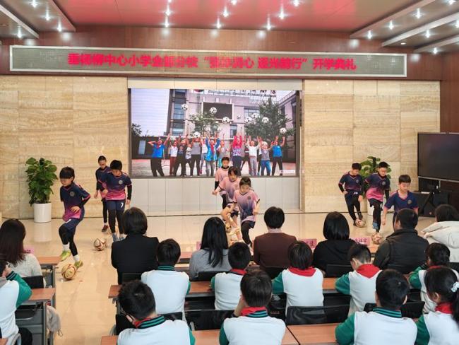 机器人在校门口迎接学生返校 智能迎宾添“智”趣