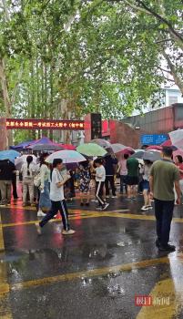 考生家長(zhǎng)冒著暴雨等在考場(chǎng)外 雨中守望助威